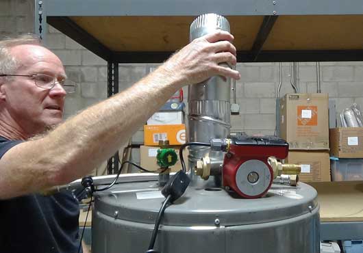 Mark Franklin sets up test equipment in the company’s warehouse in San Diego.